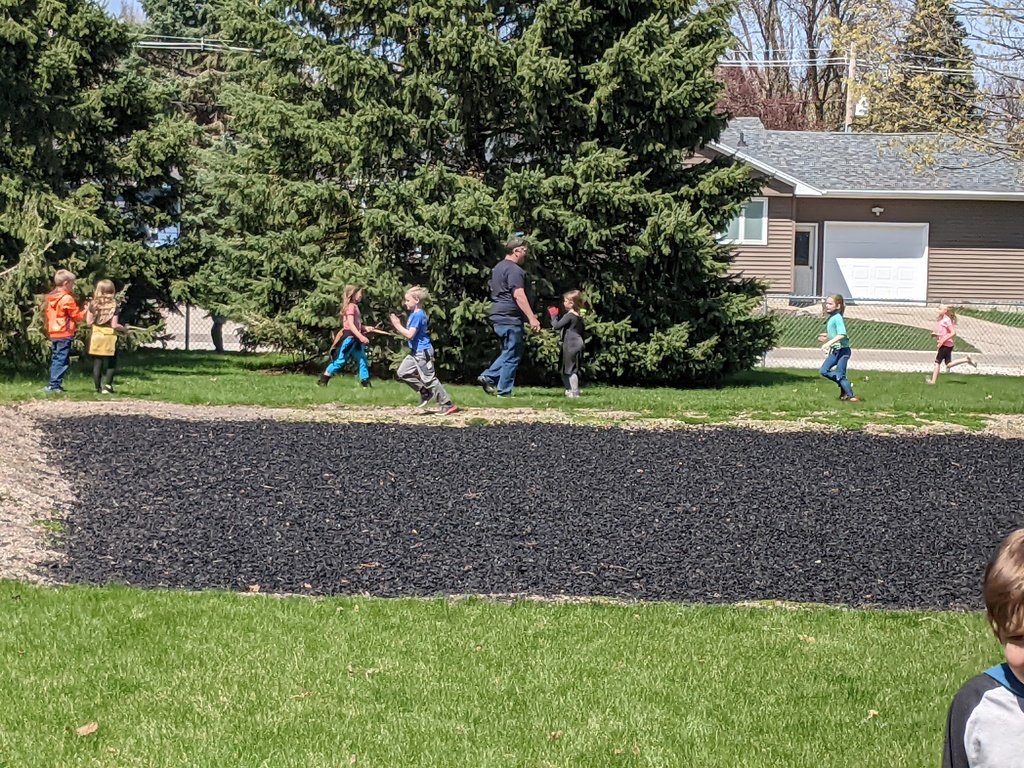 Kindergarten students helping Billy clean up the playground
